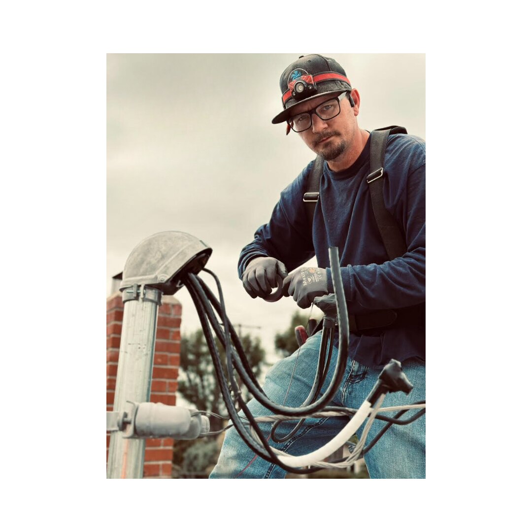 All Current Electric electrician servicing a home's electrical system in the Inland Empire