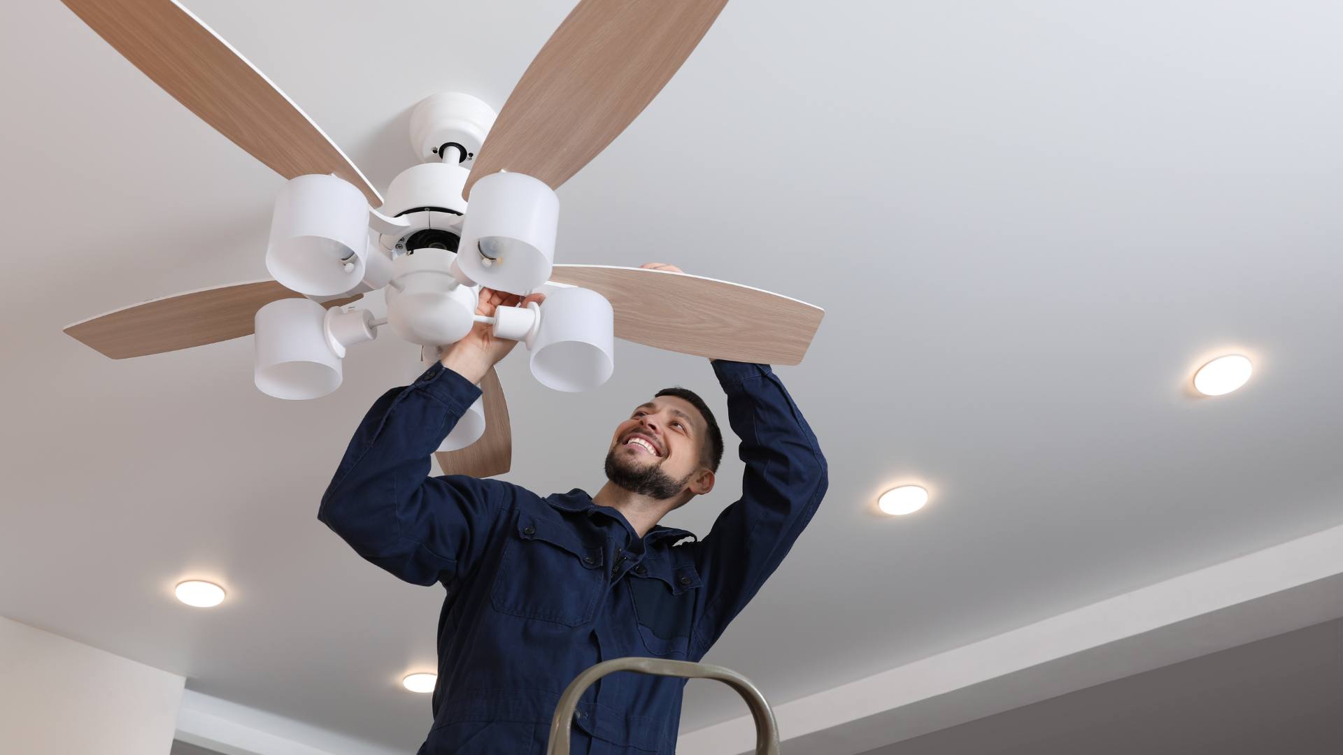 Electrician installing a ceiling fan in the Inland Empire